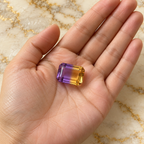 Ametrine gemstone held in hand