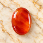 Carnelian gemstone centered on warm marble