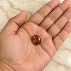 Gomed gemstone held in hand