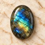 Labradorite gemstone centered on warm marble