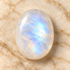 Moonstone gemstone centered on warm marble