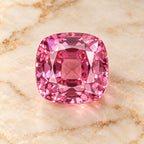 Pink Sapphire gemstone centered on warm marble