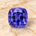 Tanzanite gemstone centered on warm marble