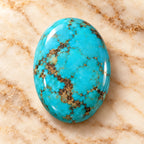 Turquoise gemstone centered on warm marble